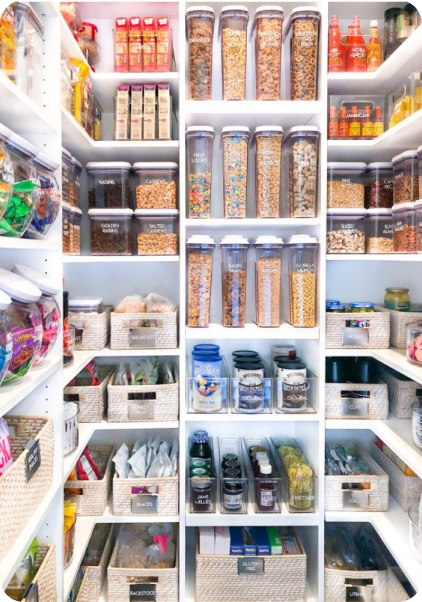 A well organized pantry with individual storage containers and shelf dividers.